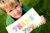 child holding a thank you sign